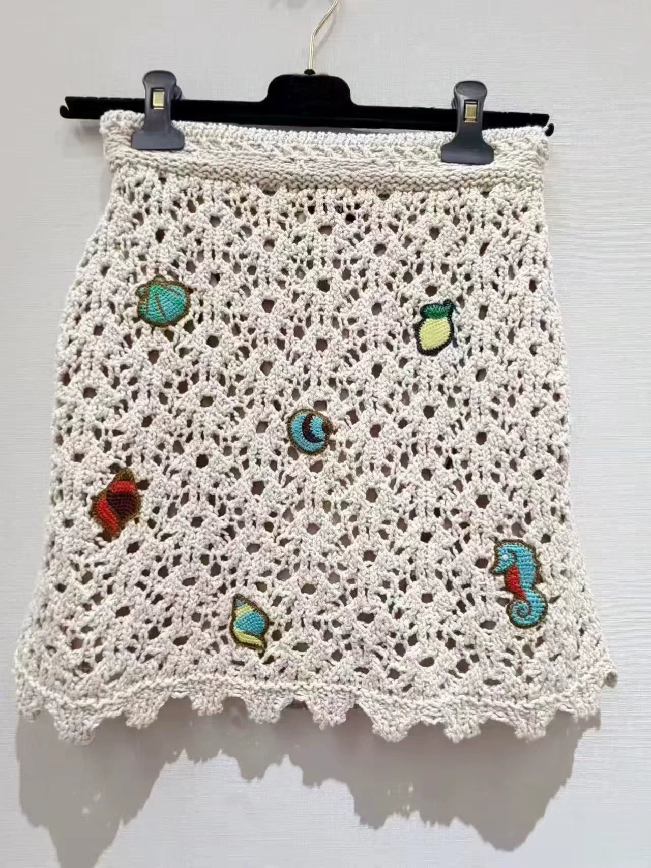 Spring and summer 26ss June, Nanyou haute couture 26M summer new holiday wind ocean embroidery lapel hollow knitted sweater elastic waist A word skirt