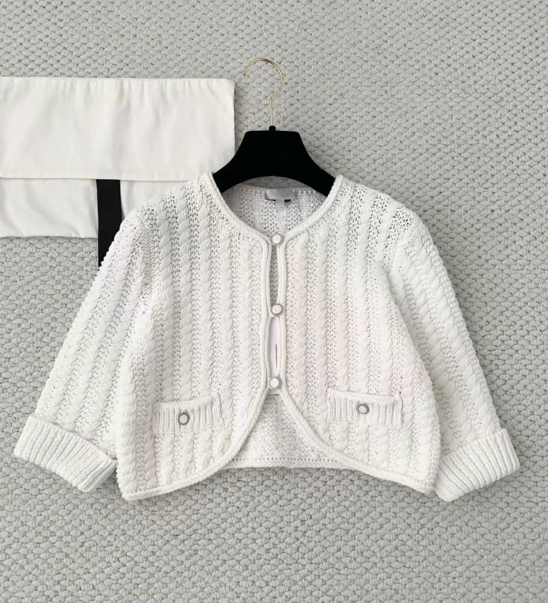 2025 autumn and winter temperament heavy industry hollow age-reducing twist knitted button-up cardigan short small long-sleeved top women